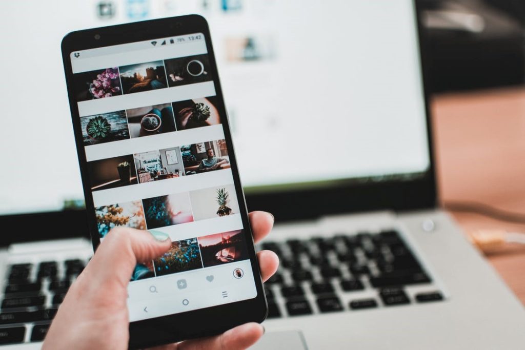 A person scrolls a curated Instagram feed on a phone.