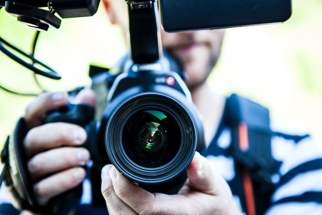 A person using a video camera to shoot a video