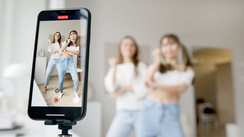 Two girls recording a video 